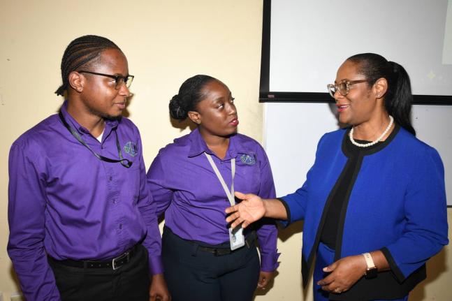 Nina Peters (right), business relationship and sales manager, JN Bank, in discussion with Gevanio Tucker (left) and Arriel Reynolds of the School of Business Administration–Accounting, University of Technology, Jamaica, during an accounting seminar held 