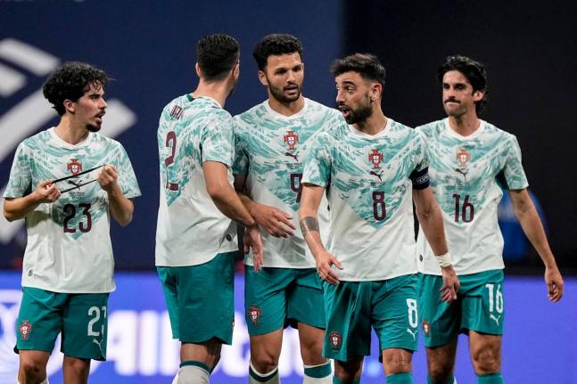 Portugal teammates celebrate a goal against the United States during the first half of an international friendly football match in Atlata, yesterday.