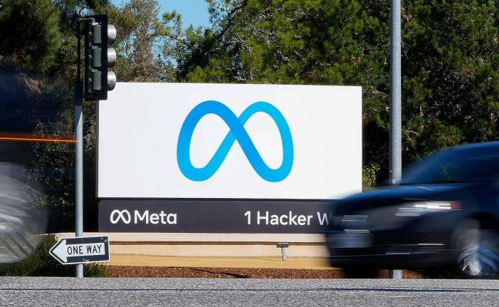 A car passes Facebook's new Meta logo on a sign at the company headquarters on October 28, 2021, in Menlo Park, Calif. (AP Photo/Tony Avelar, File)