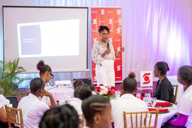 Ashley-Rae Barrett, customer service officer at Scotiabank, takes students through the basics of budgeting during the Scotia Foundation’s International Women’s Day Luncheon on March 20.