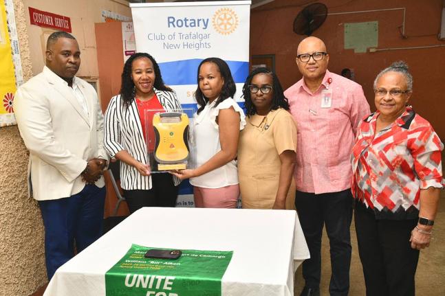 President, Rotary Club of Trafalgar New Heights, Franchesca Francis (second left), presents an Automated External Defibrillator (AED) to Medical Officer, Duhaney Park Health Centre, Dr Wendy-Ann Byfield-Lyons (third left), at the health facility in St An