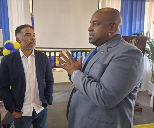 Jason Russell (left), president of the Montego Bay Chamber of Commerce and Industry, and Dwight Crawford, deputy mayor of Montego Bay, in conversation during the University of Technology, Western Jamaica Campus School of Business Administration annual semi