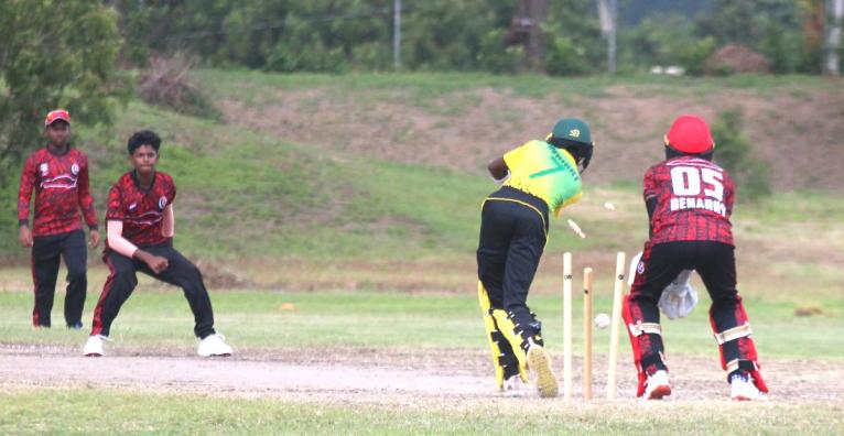 Trinidad and Tobago  leg spinner Arnaldo Premchand (second left) bowls Jamaica’s Najai Wright to win the third match of their CWI Rising Stars series at the Jamaica Broilers Ground on Thursday.