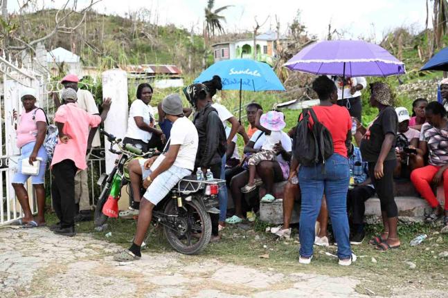 Residents gather to get food at the World Central Kitchen location in Beeston Spring, Westmoreland, during the first month after Hurricane Melissa made landfall in Jamaica last October. 