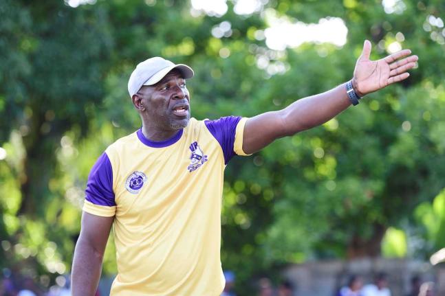Vassell Reynolds relaying instructions to players during a Kingston College Manning Cup football match.