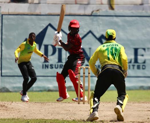 Jamaica under-15 seamer Hugh Turner (left) just before picking up with wicket of K’Hill Thomas as wicketkeeper Daniel Davidson looks on.