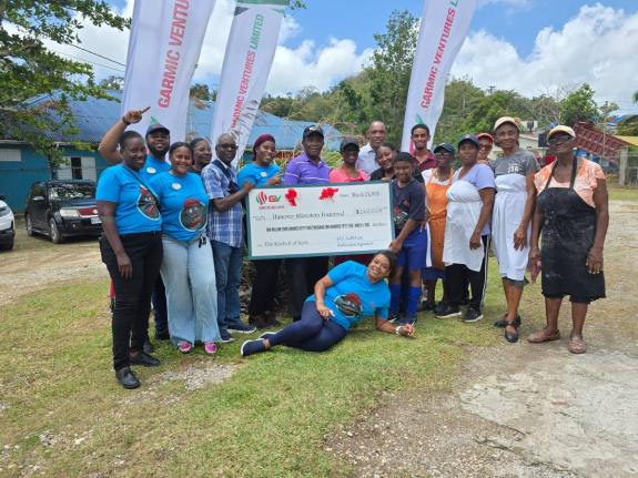 Reverend Sheldon Ashman (third left), chairman of the Hanover Ministers Fraternal, collects a symbolic cheque for $2.4 million from 12-year-old Gareson Whittaker, the son of Michelle Whittaker, managing director of GV Service Station in Hanover. Sharing in
