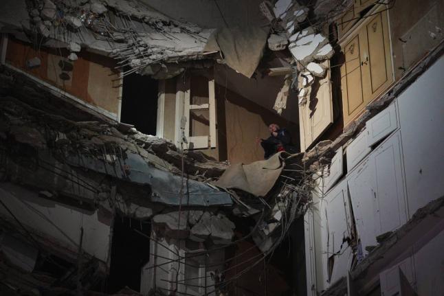 A woman stands at a destroyed apartment on a building that was hit in an Israeli airstrike in central Beirut, Lebanon, Wednesday, April 8, 2026. (AP Photo/Emilio Morenatti)