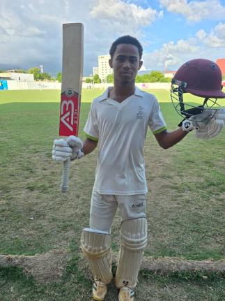 St Elizabeth Technical High School middle-order batsman, Ryan Lyttleton celebrates scoring a hundred during the ISSA/First Global Bank/GK Spaulding Cup final at the Melbourne Oval yesterday.
