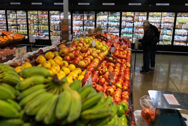 People shop at a grocery store, in Schaumburg, USA, Thursday, April 2, 2026. (AP Photo)