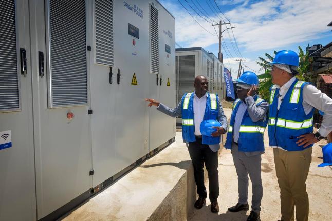 Minister of Health and Wellness, Dr Christopher Tufton (right), and CEO of the National Health Fund (NHF), Everton Anderson (centre), listen as NHF director of institutional benefits, projects and maintenance, Richard Allen, explains components of the sola