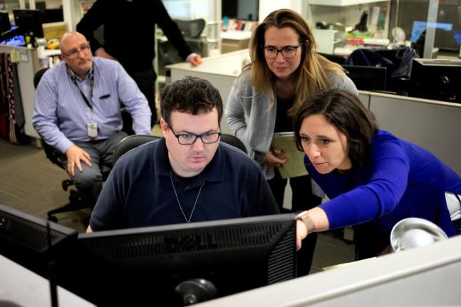Associated Press Washington Bureau Chief Julie Pace, right, looks over a headline with deputy managing editor for operations David Scott in the newsroom at the Associated Press in Washington, February 5, 2020. (AP Photo)