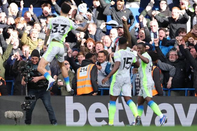 Manchester City's Nico O'Reilly celebrates after scoring during the Premier League football match between Chelsea and Manchester City in London on April 12, 2026. (AP Photo/Ian Walton)