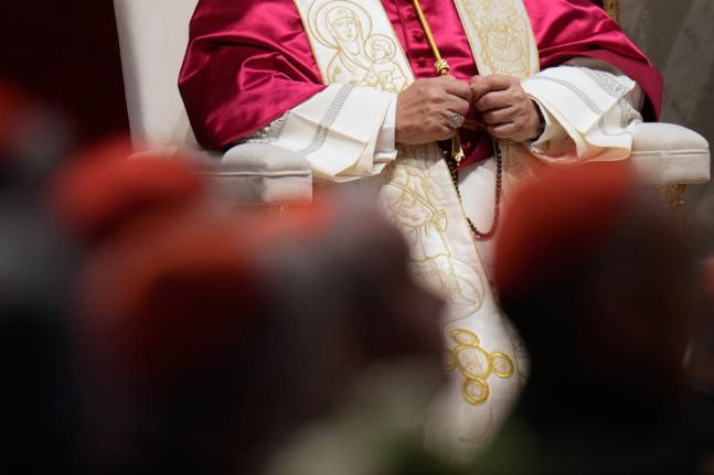 Pope Leo XIV holds a rosary as he leads a vigil for peace inside St. Peter’s Basilica at the Vatican.
