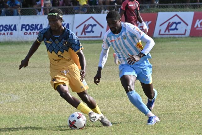 Colorado Murray (right) of Waterhouse and Racing United’s Nickyle Ellis battle for the ball during yesterday’s Jamaica Premier League match at Ferdi Neita Park. Waterhouse won 1-0.