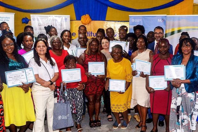 Participants in the Improving Rural Livelihoods through Resilient Agri-food Systems (IRL) Project, in the company of officials, display their certificates during the certification ceremony, held recently at the Spring Village Community Centre in St. Cather