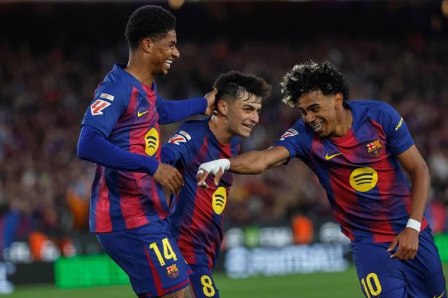 Barcelona’s Marcus Rashford (left) celebrates after scoring his side’s fourth goal with Lamine Yamal (right) and Pedri during the Spanish La Liga match against Espanyol in Barcelona, Spain, on Saturday.