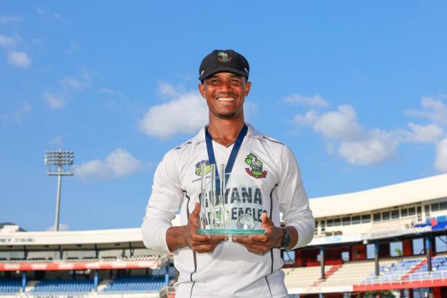 Guyana Harpy Eagles captain Tevin Imlach displays the West Indies Championship trophy his side won after their final game against the Trinidad and Tobago Red Force at Queen’s Park Oval on Saturday, April 12, 2025.