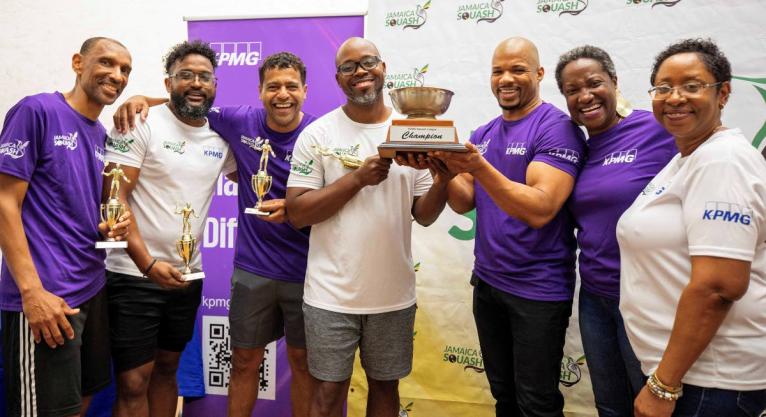 From left: Leigh Dwyer, Daren Latchman (reserve), Jerazeno Bell, and Mario O’Connor of the Saints accept the KPMG Squash League trophy from Al Johnson (third right), audit partner at KPMG, while Karen Anderson (second right), Jamaica Squash president, an