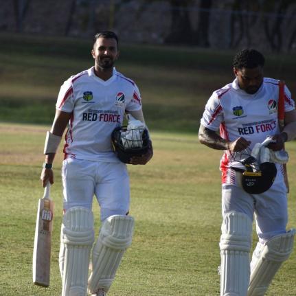 From left: Trinidad and Tobago’s Amir Jangoo and Terrance Hinds leave the pitch at Coolidge Cricket Ground in Antigua during their West Indies Championship game against the Leeward Islands Hurricanes on Monday. 