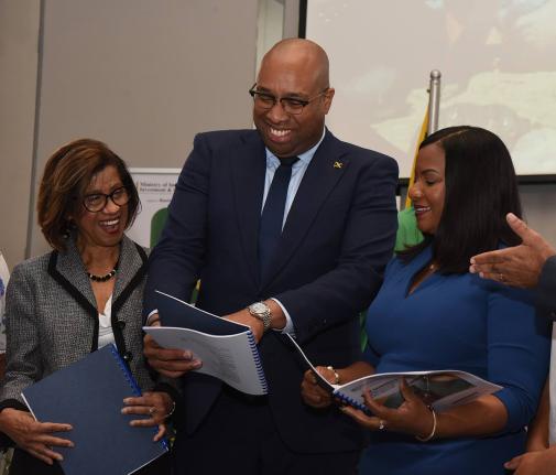 Delano Seiveright (centre), Minister of State in the ministry of Industry, Investments and Commerce, leafs through the Dangerous Drugs (Cannabis Licensing) (Interim) (Amendment) Regulations, 2025, with Sancia Bennett-Templer (left), Permanent Secretary in 