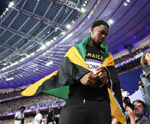 Jamaica's Roje Stona celebrates an Olympic record-breaking gold-medal performance in the men’s discus at the Stade de France in Paris, France, on Wednesday, August 7.