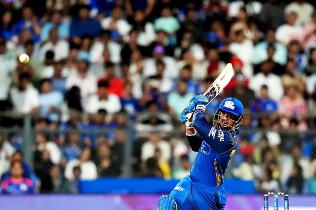 Mumbai Indians’ Quinton de Kock hits a boundary during the Indian Premier League cricket match against Punjab Kings in Mumbai, India, yesterday.