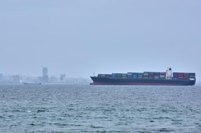 A container ship is seen in the Strait of Hormuz off the coast of Qeshm Island, Iran, Saturday, April 18, 2026. (AP Photo/Asghar Besharati)