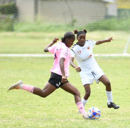 
Shennel Walters of Frazsiers Whip FC (left) gets ready to play the ball ahead of Adrianna Hall of Federal United FC during their Jamaica Women’s Premier League fixture at Excelsior High School yesterday. 