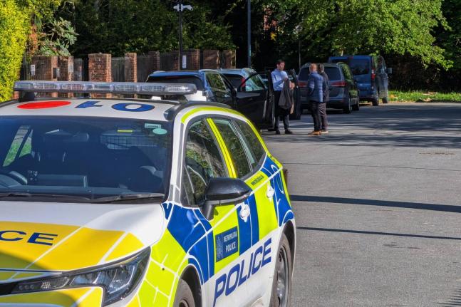 Police officers patrol at a cordon near Kenton United Synagogue in Harrow, a suburb of London.