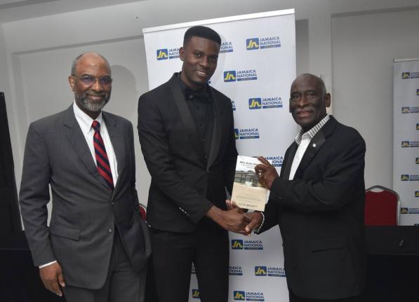 Reverend Ulit Brackett (right) holds a copy of his new book with Shevauni Powell (centre), Mr Supranational Jamaica 2025 and former head boy of Mile Gully High School. Sharing the moment is Earl Jarret, chief executive officer of the JN Group.