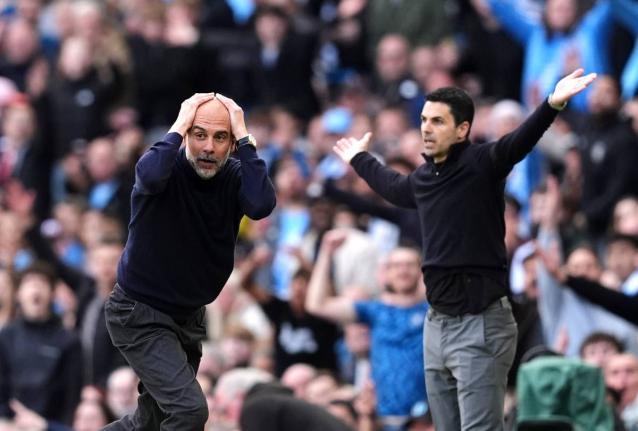 Manchester City’s head coach Pep Guardiola and Arsenal manager Mikel Arteta react during their English Premier League  match in Manchester, England, yesterday.