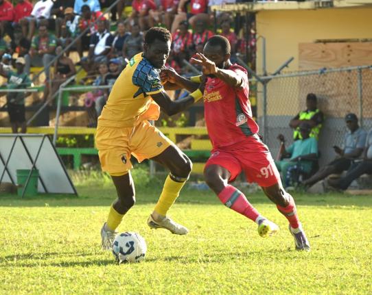 Racing United’s Odane Nish (left) tries to stop Montego Bay United’s Owayne Gordon from rounding him during their Jamaica Premier League game at Jarrett Park in Montego Bay yesterday. 