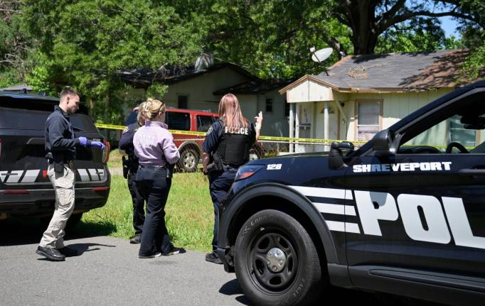 Police gather in front of a house on Harrison Street near Bernstein Avenue, in Shreveport, La., as they investigate a mass shooting, Sunday, April 19, 2026. (Jill Pickett/The Times-Picayune/The New Orleans Advocate via AP)