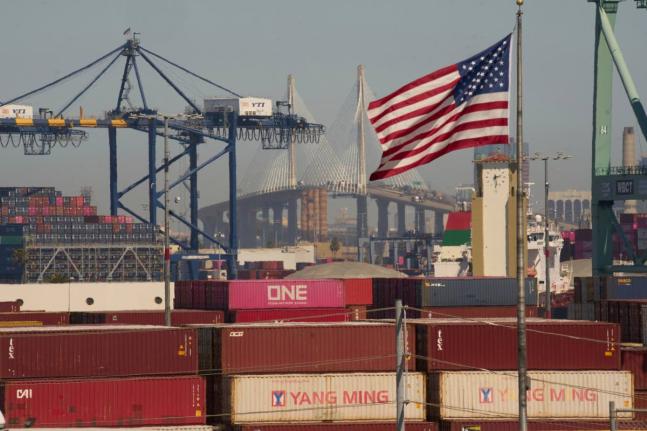 FILE - Containers with Yang Ming Marine Transport Corporation, a Taiwanese container shipping company, are stacked up at the Port of Los Angeles with the the Long Beach International Gateway Bridge seen in the background on Wednesday, April 9, 2025 in Los 