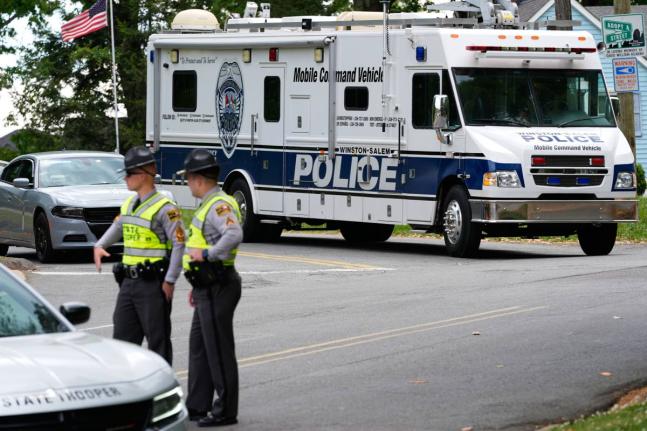 A police mobile command vehicle leaves the the scene of a shooting at Leinbach Park on Monday, April 20, 2026, in Winston-Salem, N.C. (AP Photo/Erik Verduzco)