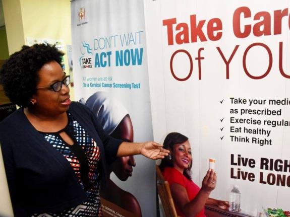 Director of Non-Communicable Diseases and Injuries Prevention, Ministry of Health and Wellness, Dr Tamu Davidson, points to a health promotion flyer during a recent interview with JIS News at her New Kingston offices.