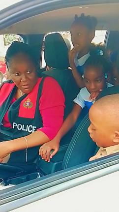 Green Acres Police Station Manager Sergeant Clarine Brooks demonstrates the features of a police vehicle to students of St John’s Primary during a recent road‑safety and transportation session.