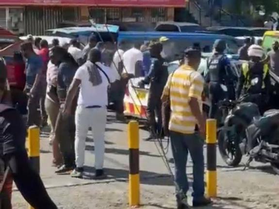 A police team among a crowd on Chancery Avenue in St Andrew on April 21, 2026.