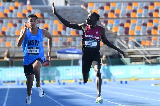 Gout Gout (right) waves while winning the junior 100 metres at the Australian Athletics Junior Championship in Brisbane on Saturday.