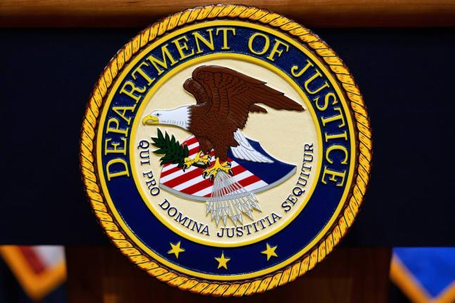 FILE - The US Department of Justice logo is seen on a podium before a news conference at the Justice Department in Washington, on May 6, 2025. (AP Photo/Julia Demaree Nikhinson, File)