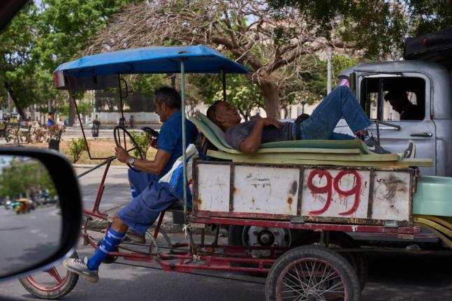 A man rests on mattresses atop a bicycle trailer in Havana, Wednesday, April 22, 2026. (AP Photo/Ramon Espinosa)