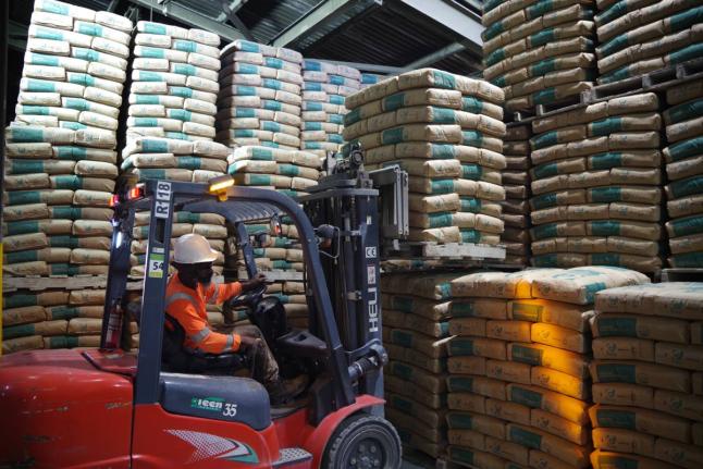 A forklift operator loading cement for transport.