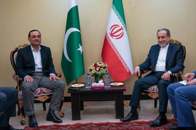 In this photo released by the Iranian Foreign Ministry, Iranian Foreign Minister Abbas Araghchi, right, meets with Pakistan's Army Chief Field Marshal General Asim Munir in Tehran.