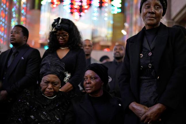 Esther Lungu, widow of Zambia’s former President Edgar Lungu (centre) and family members attend a Mass at the Cathedral of Christ the King in Johannesburg, South Africa, on June 25, 2025.