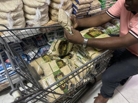 A supermarket worker in Negril removes packages of sugar produced by Pan-Caribbean Sugar Company Limited from shelves on Thursday following a health and recall alert.