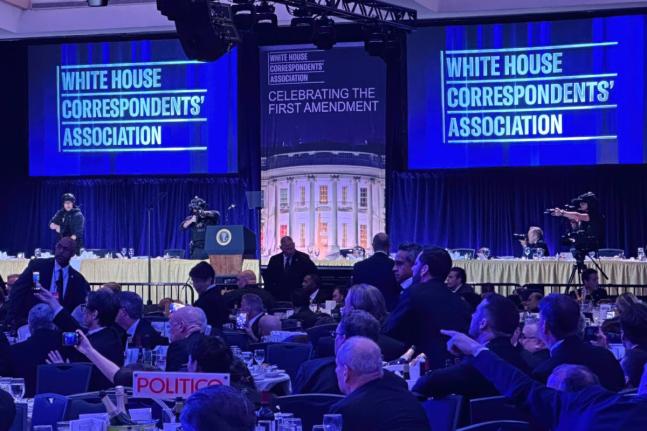 Members of the US Secret Service counter assault team stand on the stage after a shooting incident outside the ballroom during the White House Correspondents Dinner.