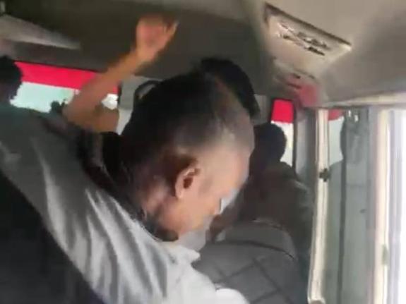 A screenshot from a video showing a bus conductor assaulting two Corporate Area schoolgirls.