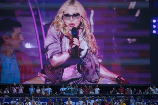 Spectators watch as Madonna performs during halftime of the World Cup final soccer match between Spain and Argentina on July 19.