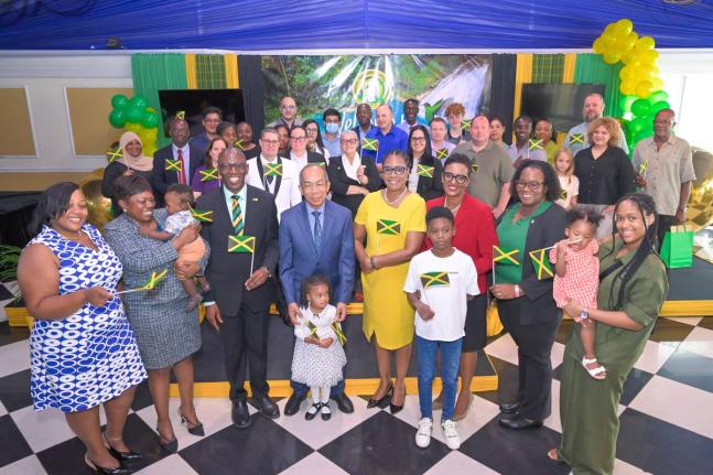 Deputy Prime Minister and Minister of National Security and Peace, Dr Horace Chang (front row, fourth left), is surrounded by 30 individuals who have been granted Jamaican citizenship, at the Citizenship Oath Ceremony held at the Terra Nova All-Suite Hotel